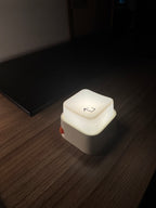 Keylight Mini one-press lamp glowing on a desk in a dim room