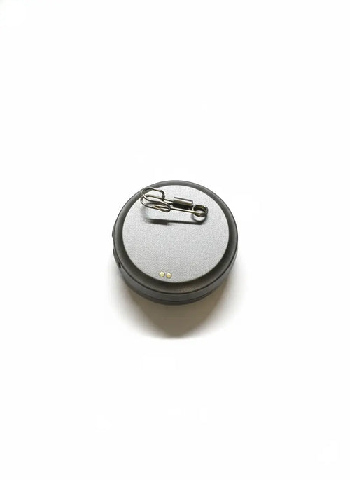 Back view of smart LED badge showing magnetic pin attachment for clothing