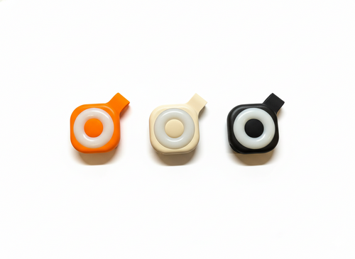 Wearable magnetic clip flashlight color options in orange cream and black